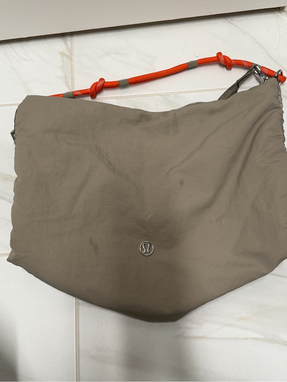 Lululemon taupe crossbody bag with orange strap 16L